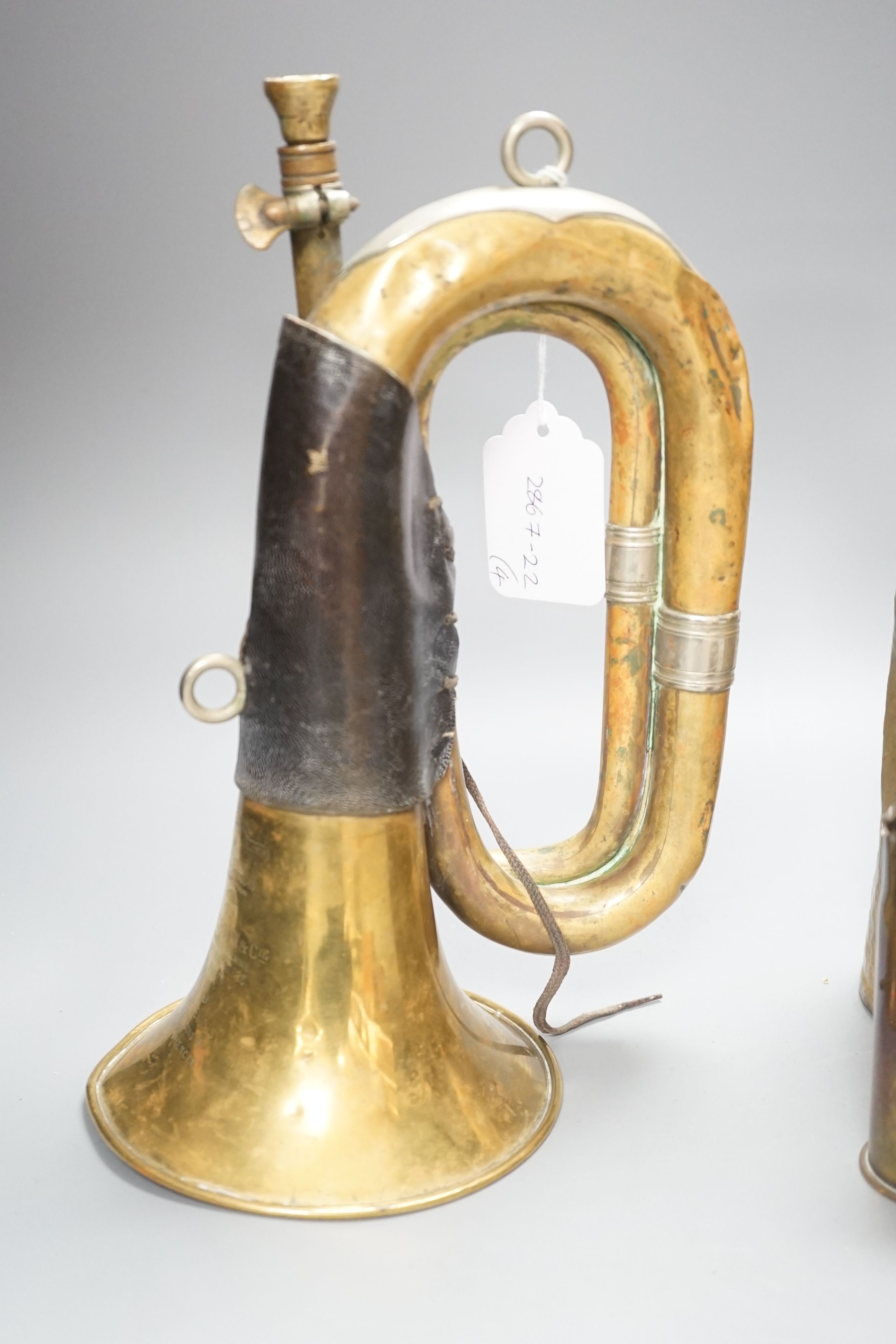 Three WWI brass trench art shell cases and a Couesnon & Cie brass bugle